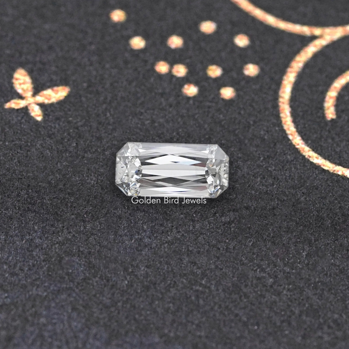 Rectangular lab-grown diamond with step-like facets on dark display surface