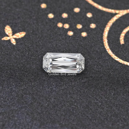 Rectangular lab-grown diamond with step-like facets on dark display surface