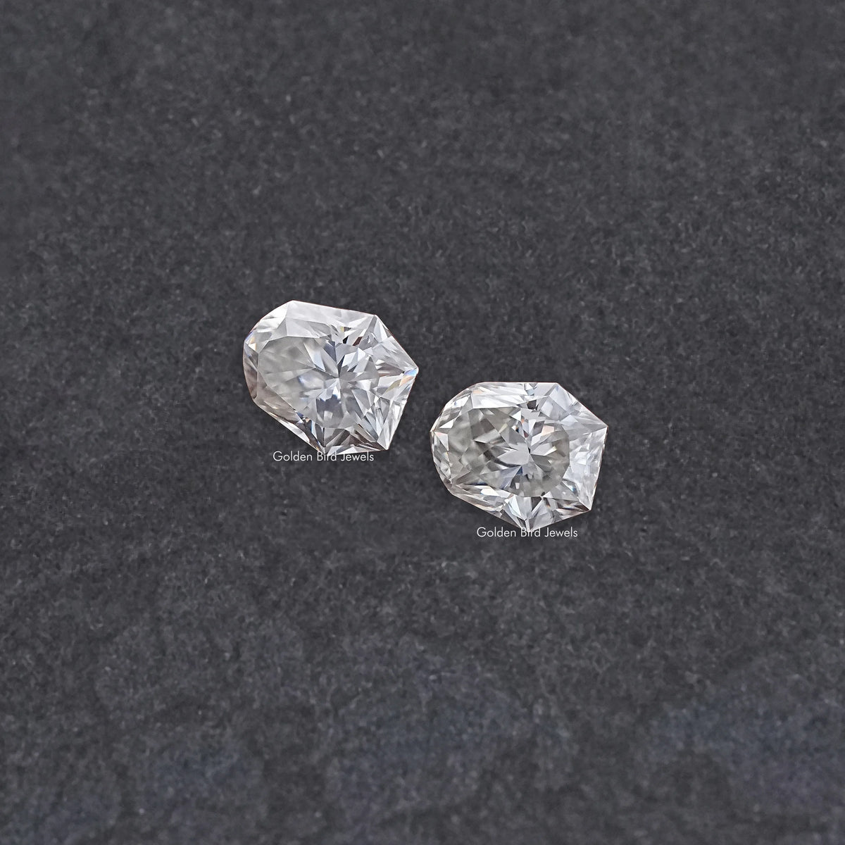 Shield-cut moissanite gemstones pair, clear faceted stones in a two-stone layout