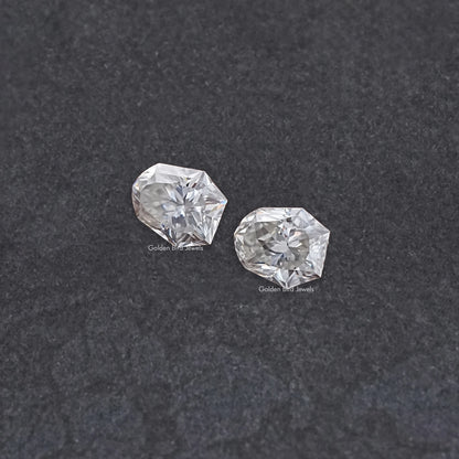 Shield-cut moissanite gemstones pair, clear faceted stones in a two-stone layout