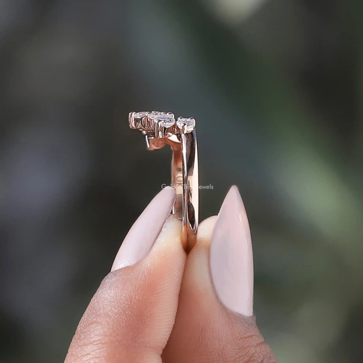 Curved rose-gold band with prongs and small round diamonds on top