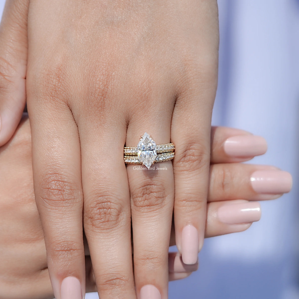 Moissanite bridal ring set on hand, marquise center stone with side bands