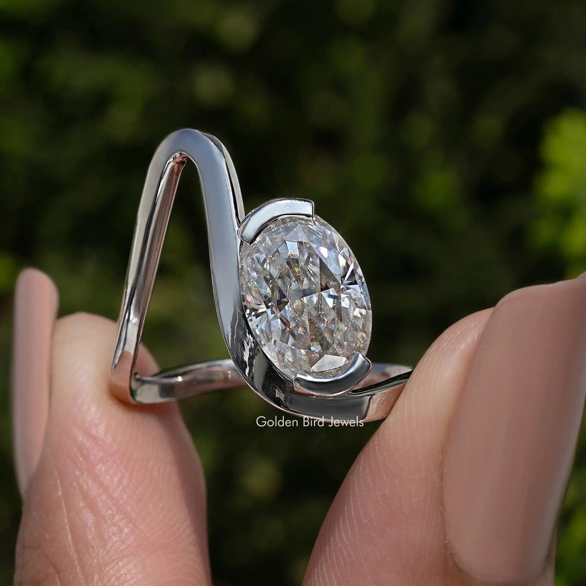 Oval moissanite solitaire ring with curved 925 sterling silver band, side view