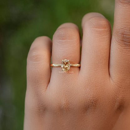 Oval moissanite solitaire engagement ring with slim gold band and small side stones
