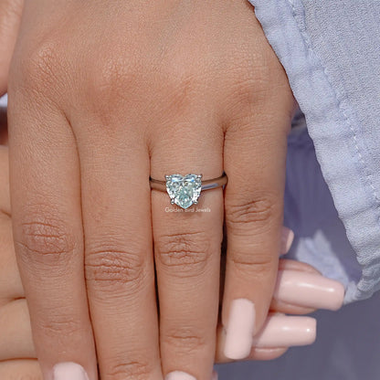 Sterling silver solitaire ring on finger, faceted gemstone center setting