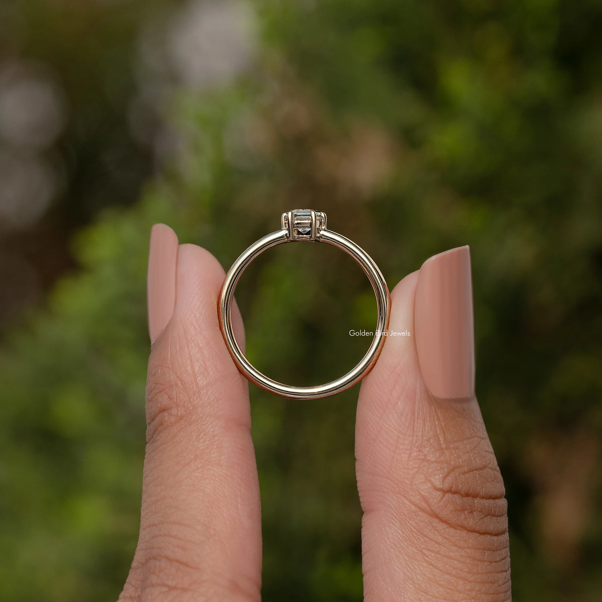 Gold-tone solitaire ring band with prong-set baguette-cut moissanite center stone