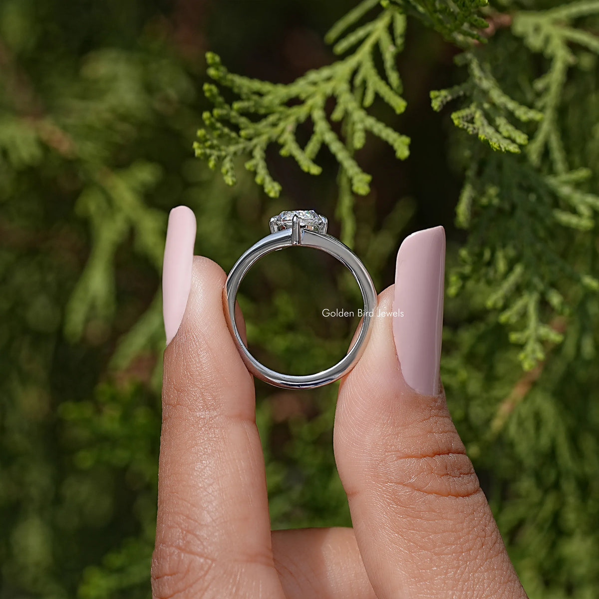 Silver split-shank solitaire ring, marquise-cut moissanite set from above, open band
