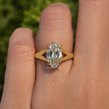 Yellow gold-tone split shank oval moissanite engagement ring with 4-prong setting
