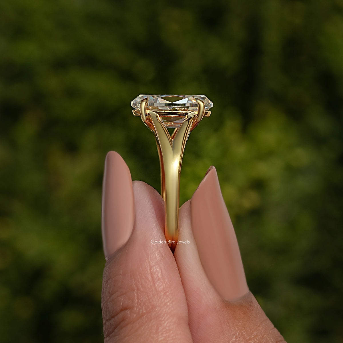 Yellow gold-tone oval moissanite engagement ring with split shank and raised center