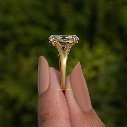 Yellow gold-tone oval moissanite engagement ring with split shank and raised center