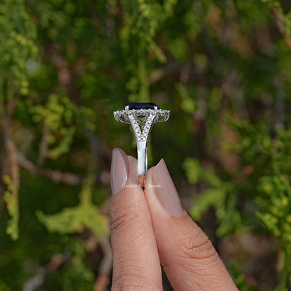 Top view of split shank oval sapphire halo ring, prong-set center