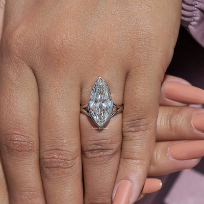 Marquise lab-grown diamond ring close-up on hand with split prongs at the sides