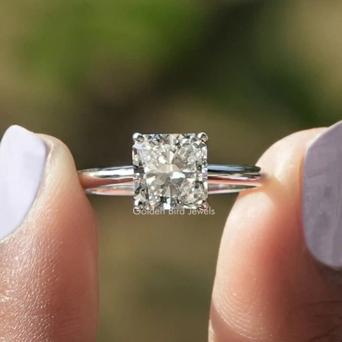 Two fingers holding the Square Radiant Cut Lab Diamond Solitaire Ring