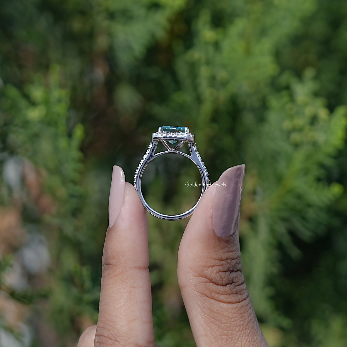 Back view of Round Moissanite Three Stone Bezel Set Ring in secure setting