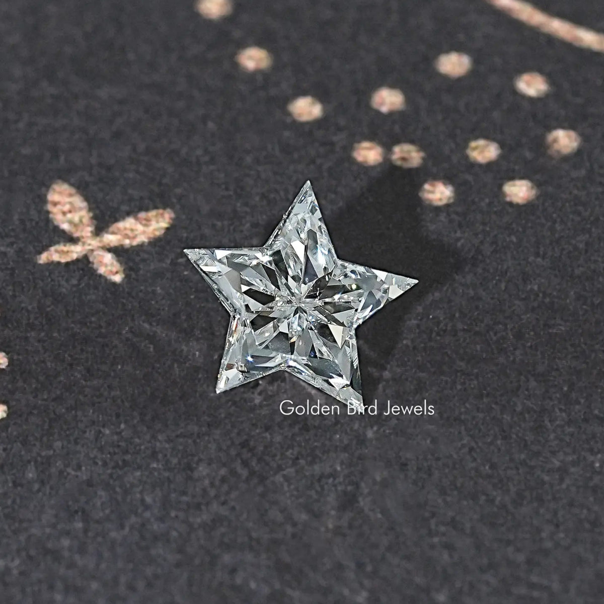 Star-cut lab diamond with clear faceted sparkle on dark fabric surface