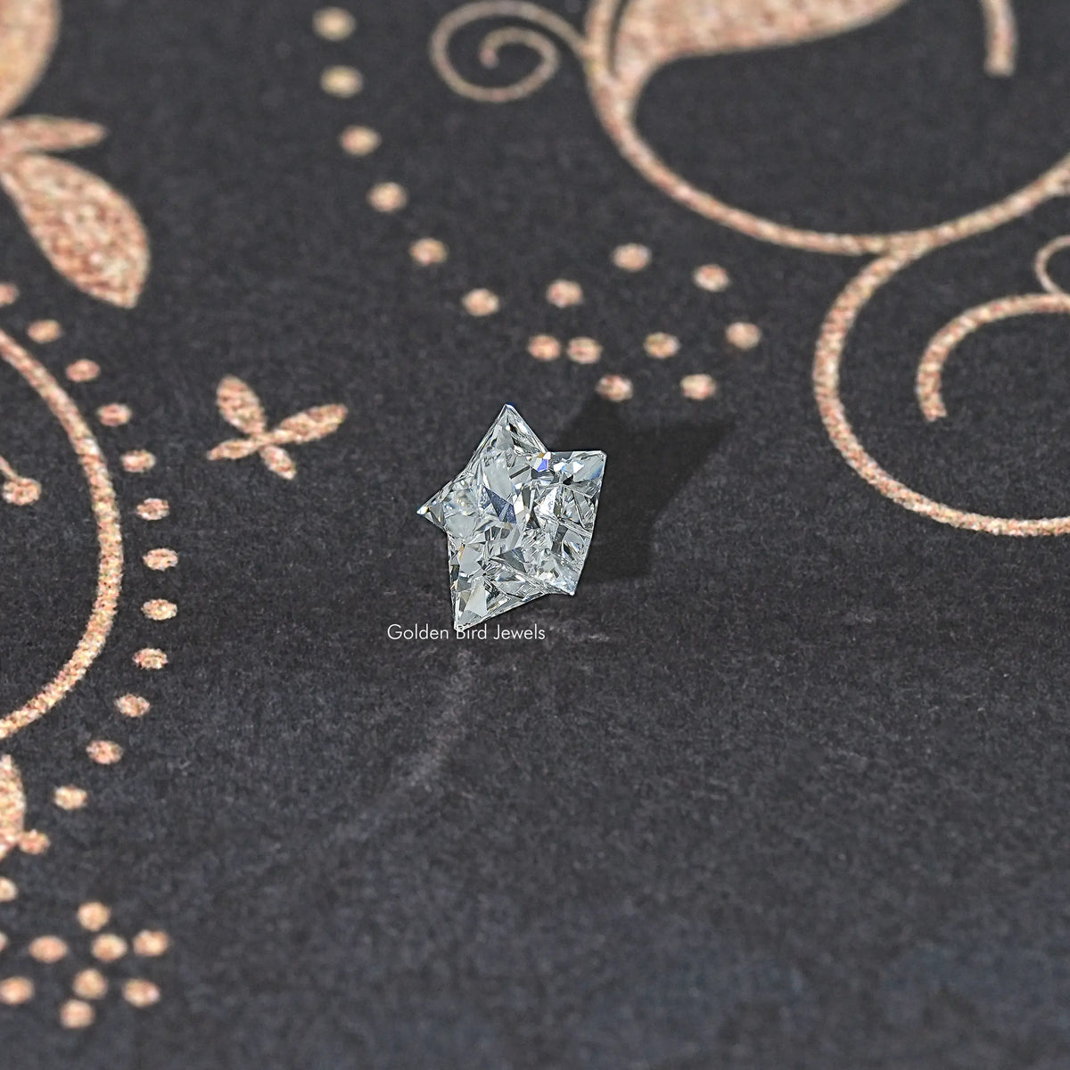 Star-cut lab diamond, clear faceted stone on dark fabric