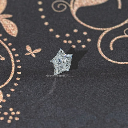 Star-cut lab diamond, clear faceted stone on dark fabric