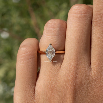 Gold-tone marquise step-cut moissanite ring on hand with slender band