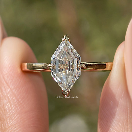 Gold-tone ring with large marquise step-cut moissanite, detailed prong setting