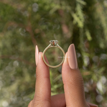 Gold-tone ring showing marquise step-cut moissanite from behind, open band