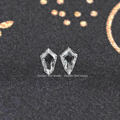 Pair of step-cut lab-grown diamond studs with geometric facets.