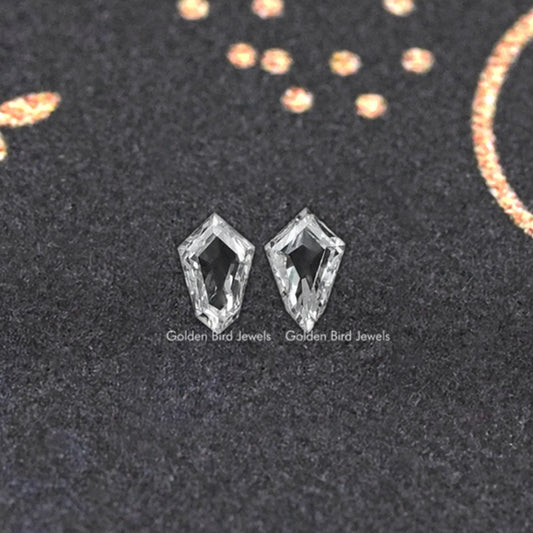 Pair of step-cut lab-grown diamond studs with geometric facets.