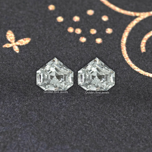 Pair of clear step-cut lab-grown diamond studs with faceted sparkle