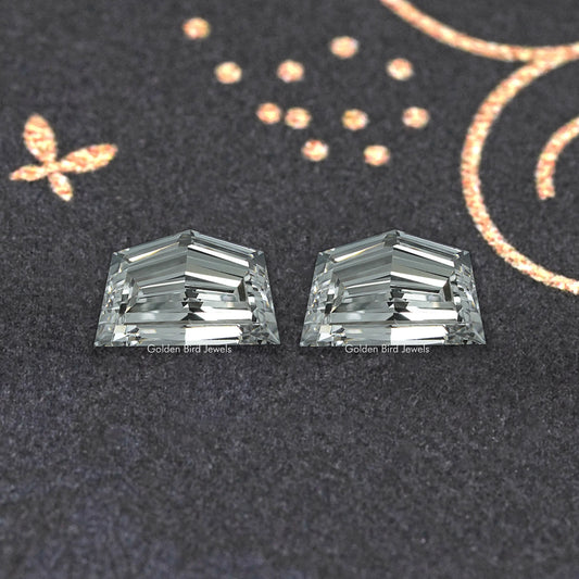 Two rectangular emerald-cut lab-grown diamonds with step facets, clear