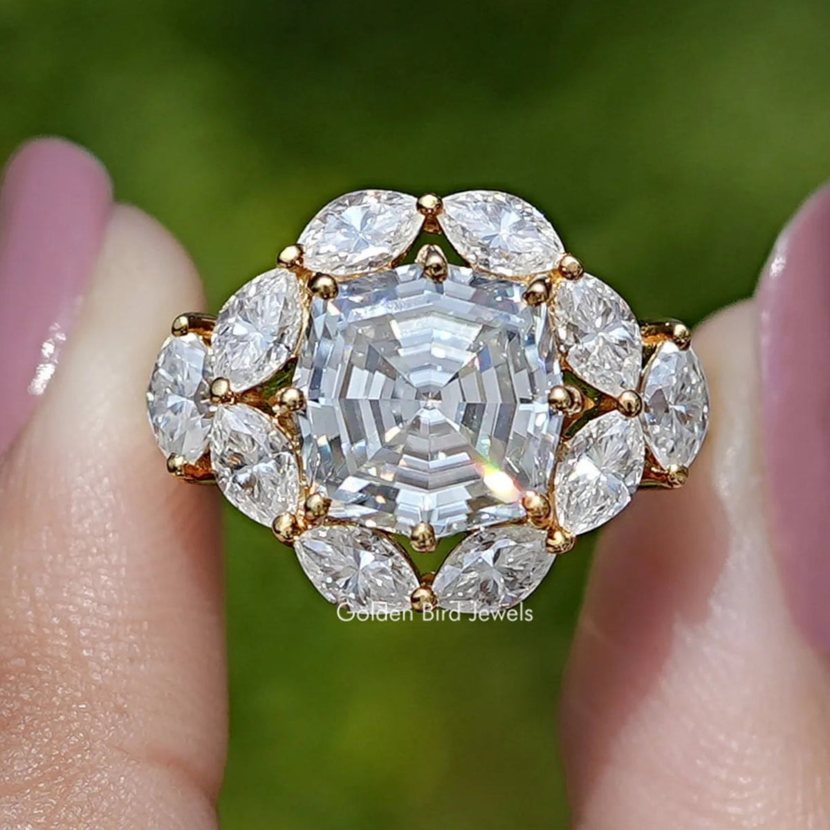 14K yellow gold halo engagement ring with step-cut center and oval side stones