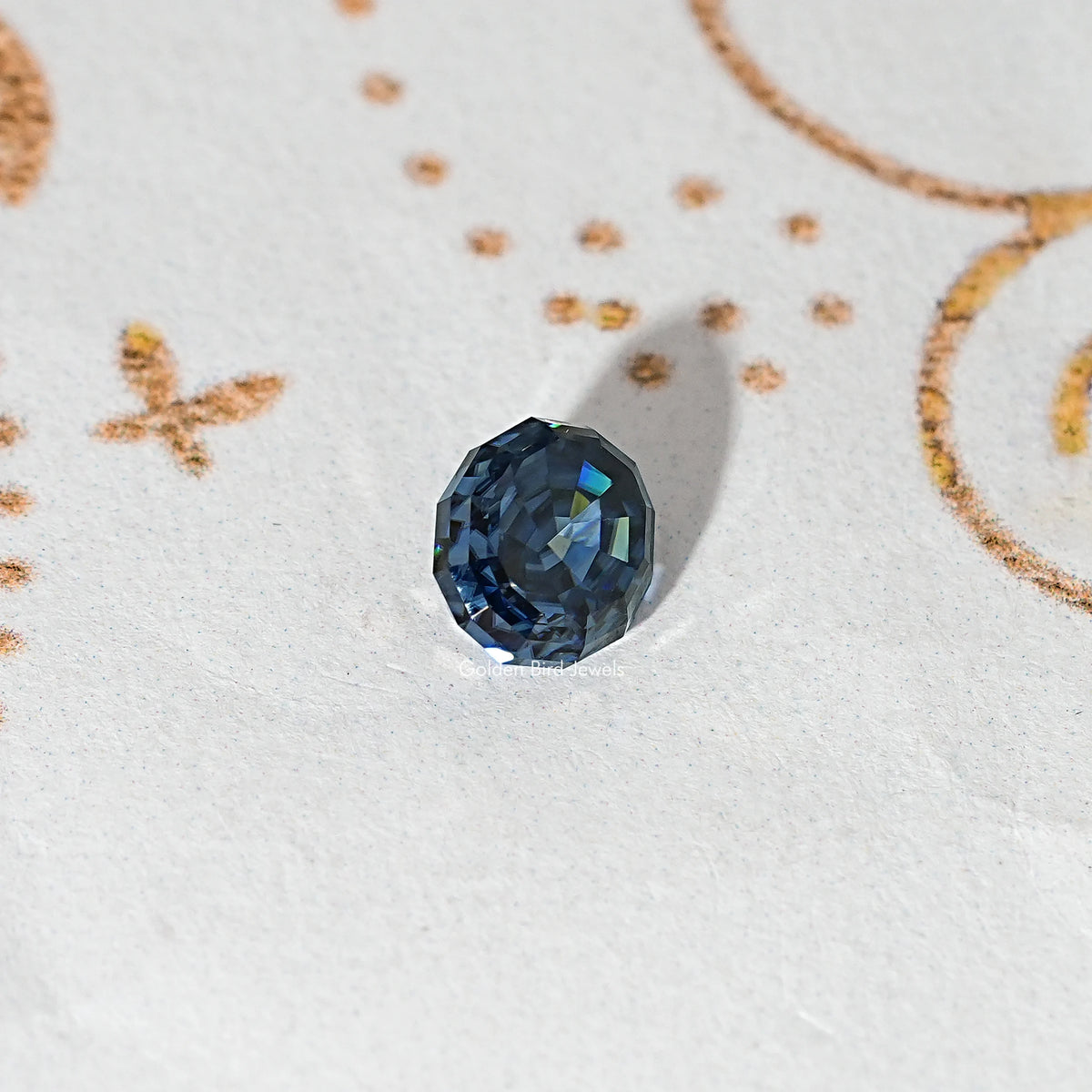 Loose step-cut oval blue moissanite gemstone with dark blue facets