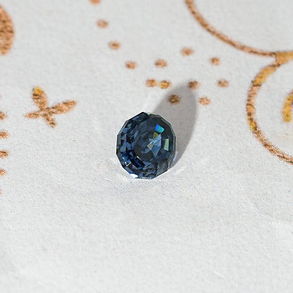 Loose step-cut oval blue moissanite gemstone with dark blue facets