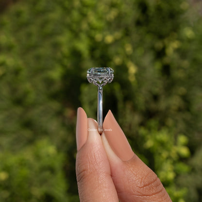 Oval teal step-cut solitaire with hidden halo, sterling silver prong basket top view