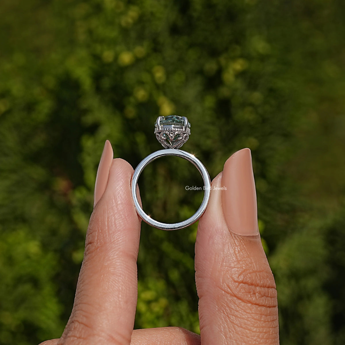 Sterling silver ring band and hidden halo setting, back view of oval teal gemstone