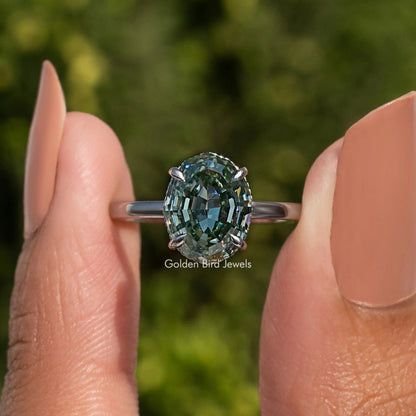 Oval step-cut solitaire ring in sterling silver with hidden halo and teal gemstone front view