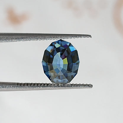 Loose step-cut oval blue moissanite gemstone with vivid blue facet flashes