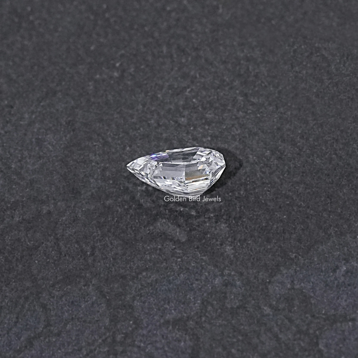 Lab-grown pear-cut diamond, step-cut faceting, loose stone close-up