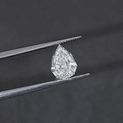 Lab-grown pear-cut diamond held between metal tweezer tips, step-cut facets
