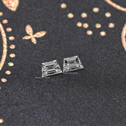 Trapezoid step-cut lab diamond stud earrings pair, horizontal profile with facets