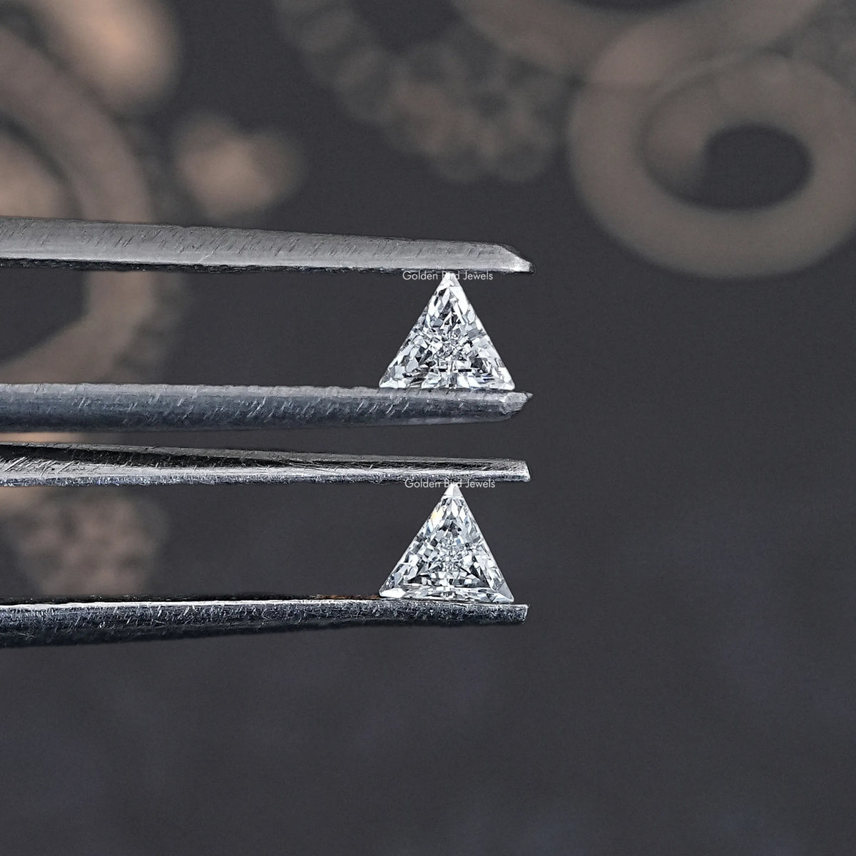 Step-cut triangle lab-grown diamonds in silver settings, close-up from top