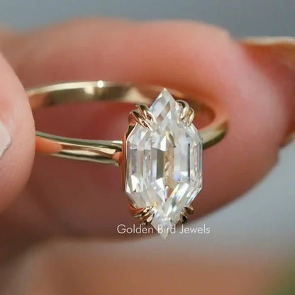 Gold-toned ring with oval marquise moissanite center stone, step-cut facets