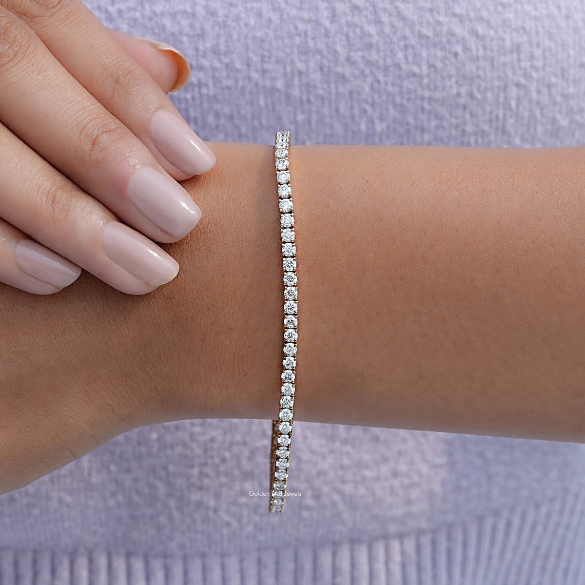 White round-cut tennis bracelet with stone row on wrist