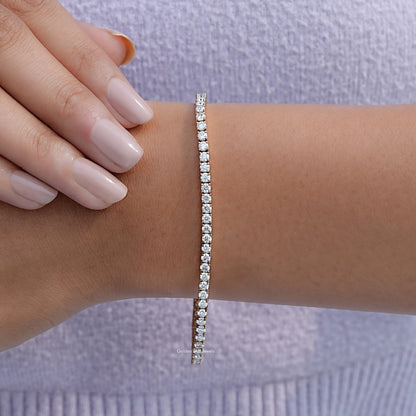White round-cut tennis bracelet with stone row on wrist