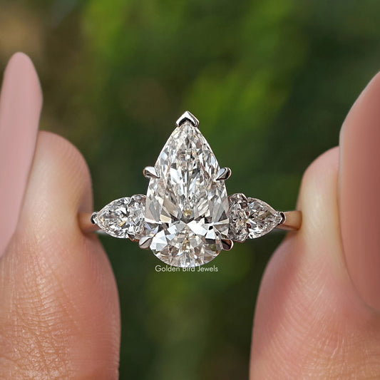 Three-stone pear-cut diamond engagement ring, large center pear with two side diamonds