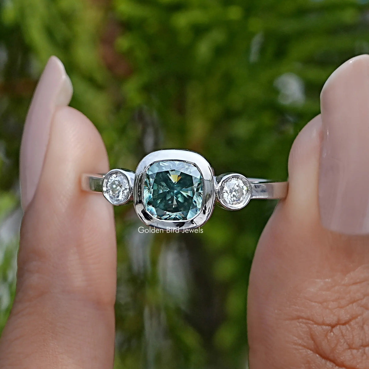Three-stone cushion-cut moissanite ring with round side stones, silver band