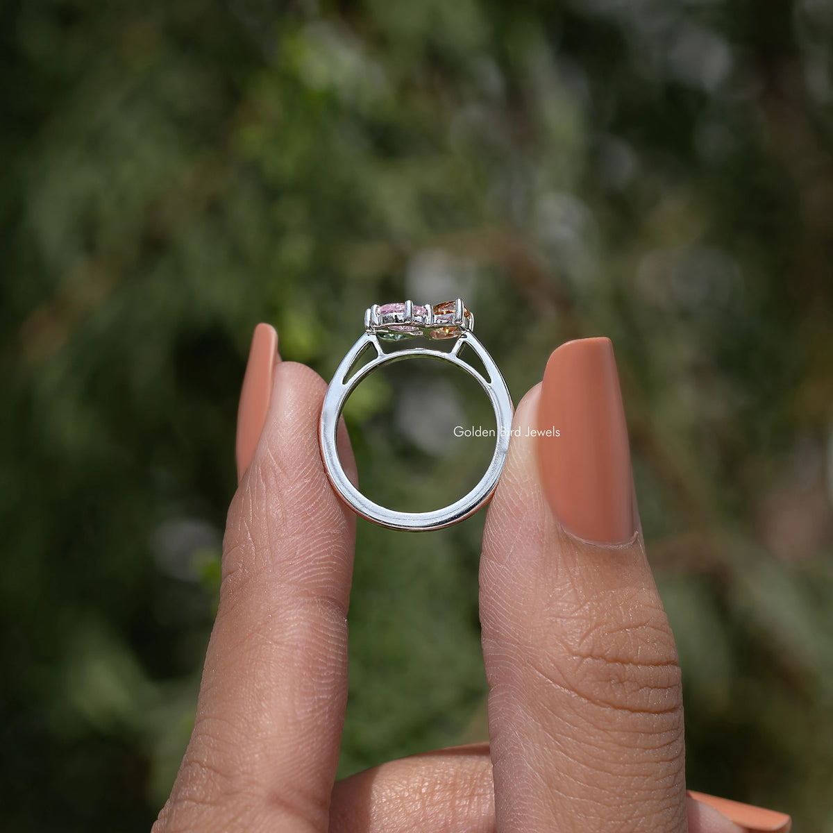 Three-stone engagement ring showing the band and four-prong top setting