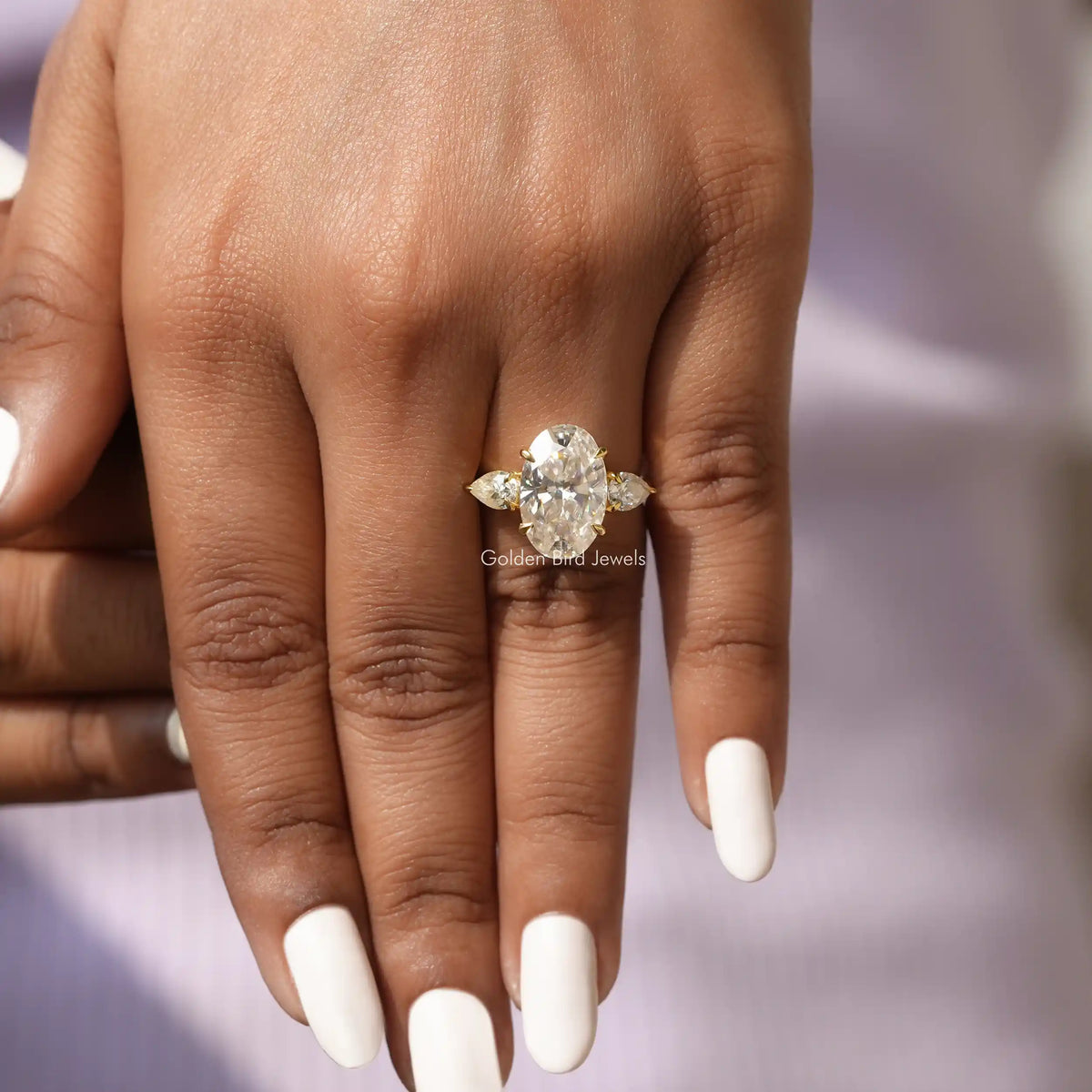 View of Moissanite Oval And Pear Cut Ring In Yellow Gold