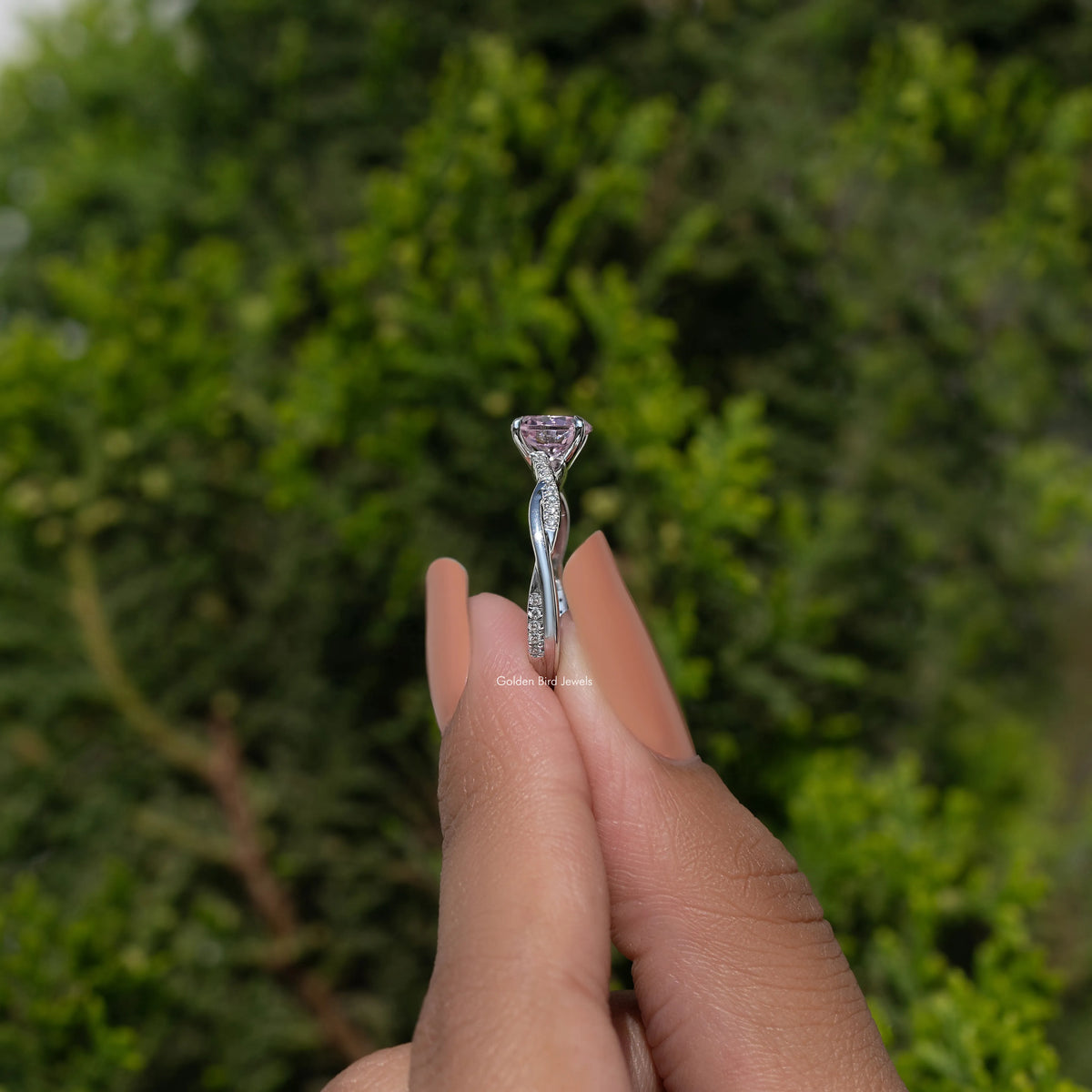 Sterling silver ring with pink faceted gemstone in prong setting