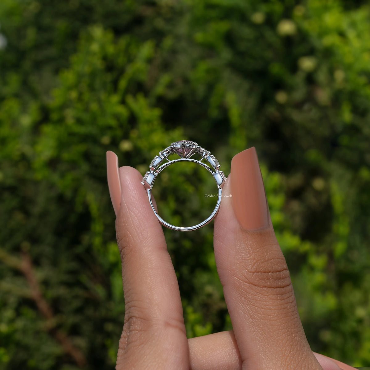 Argentium silver halo ring with pear-shaped pink gemstone, top view on fingers