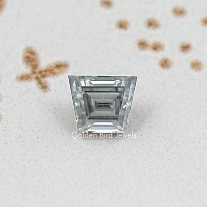 Gray trapezoid-cut moissanite gemstone with multi-step rectangular facets