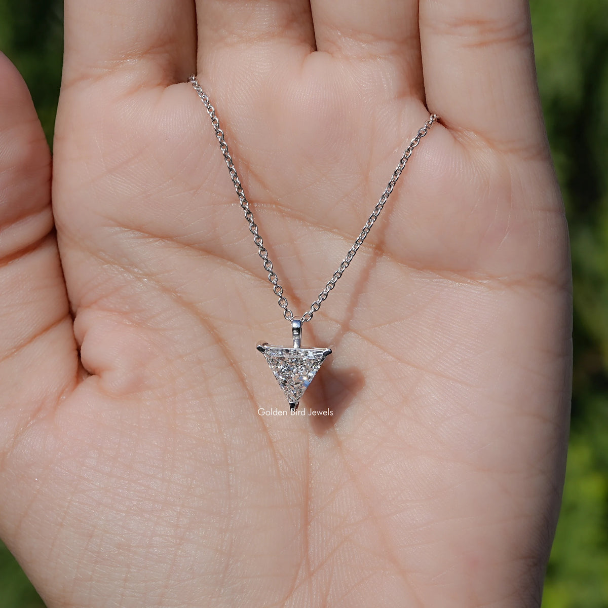 In Hand Showing View Of Lab Diamond Solitaire Necklace 

